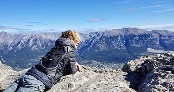 Travel Like This editor Lisa Monforton gazing over Ha-Ling-Peak Canmore Alberta