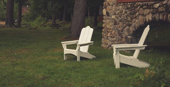 Outdoor chairs on lawn in backyard Money tight? Take a staycation
