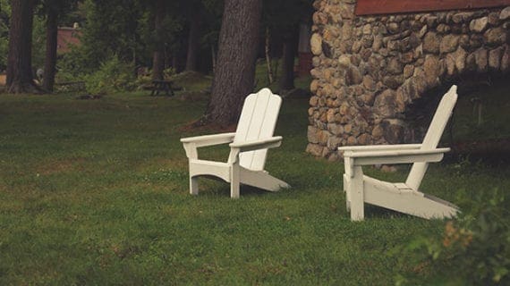 Outdoor chairs on lawn in backyard Money tight? Take a staycation