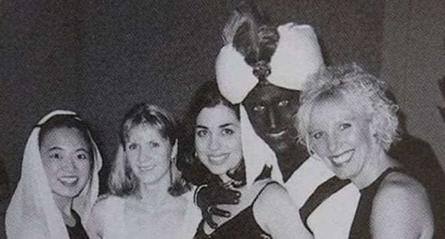 Justin Trudeau in blackface, with hand splayed across woman's chest