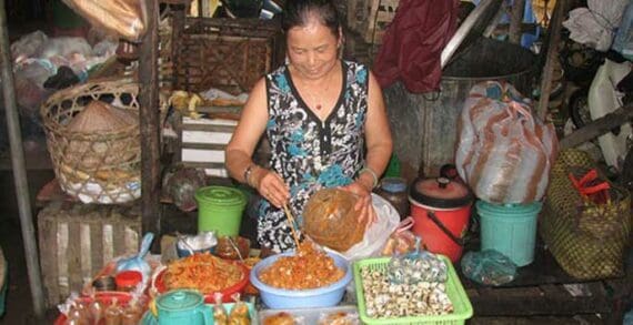 An open air market in Vietnam Dampening Asian demand cools crude oil prices