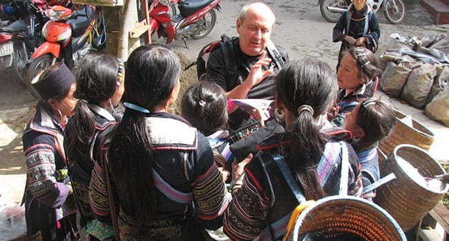 Geoff surrounded by Vietnamese women selling wares in Sapa